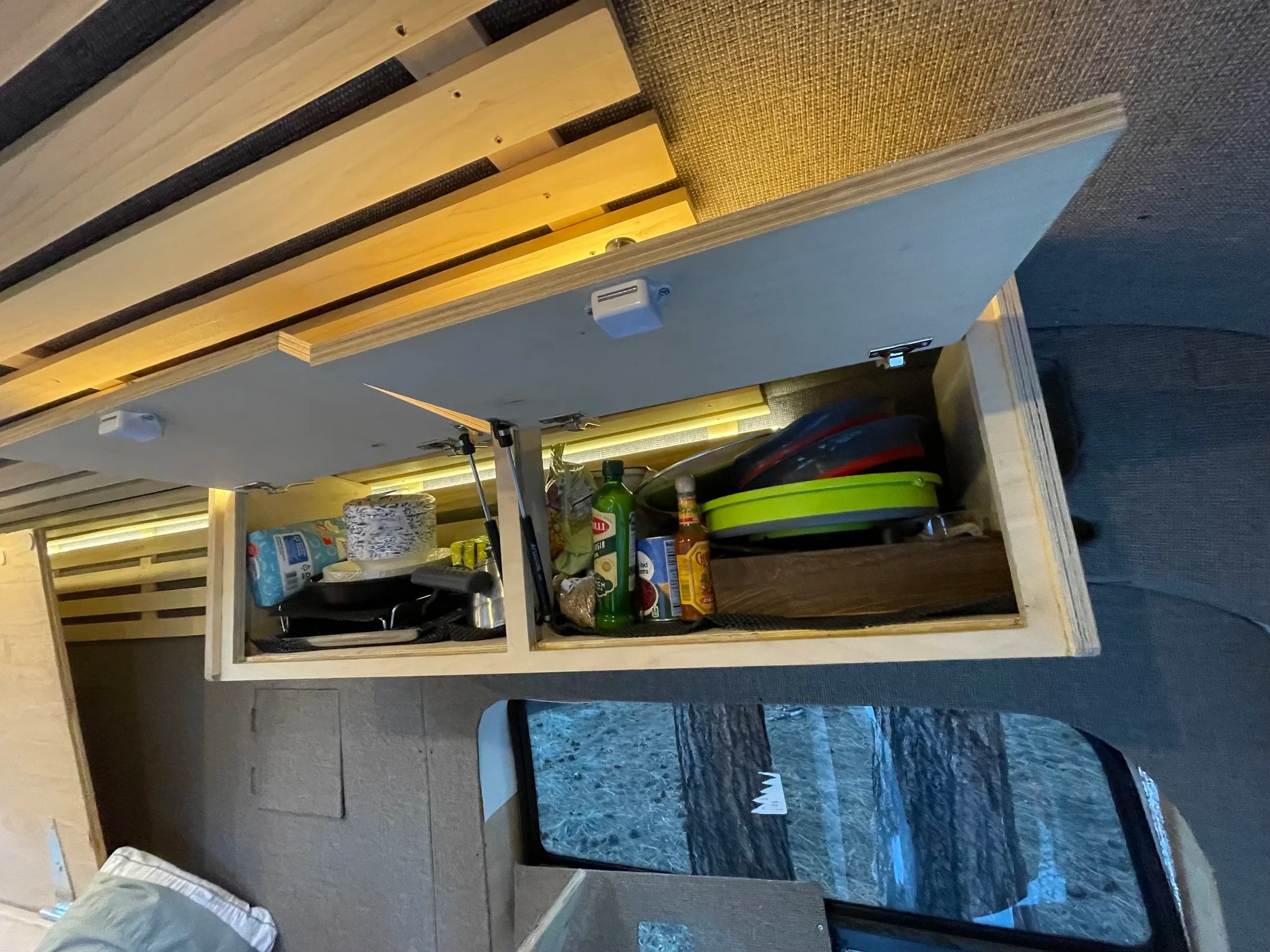 Overhead cabinet storage with kitchen supplies organized